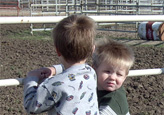 Hunter and Skyler Dugan watch Grandma Carol in the arena